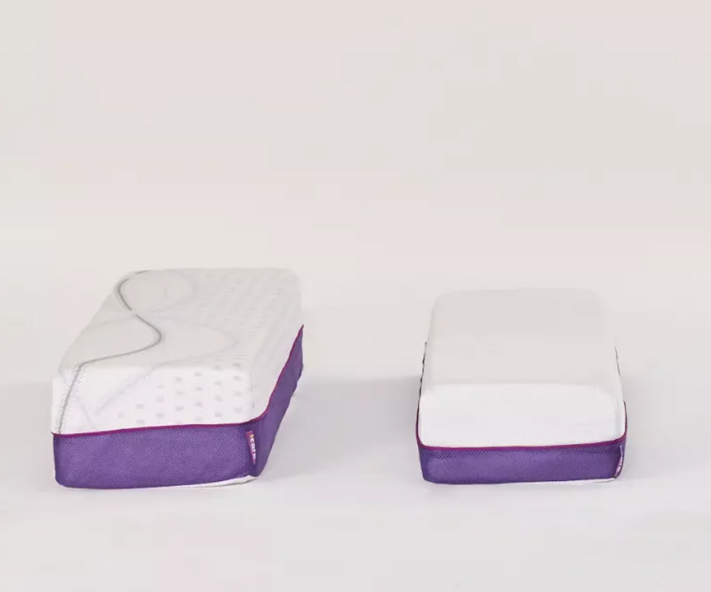Two white rectangular mattress or cushion-like products with purple fabric sides, shown side by side on a clean white studio background.