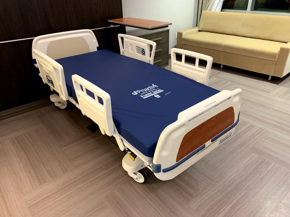 StrykerSecure2HospitalBed Hospital bed in a room with a couch and desk