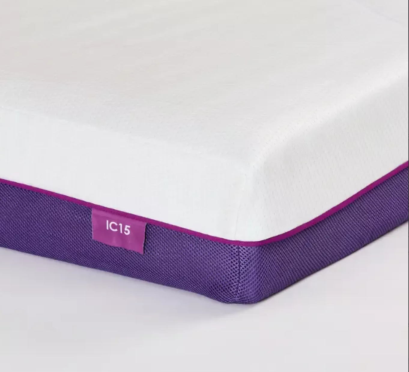 A close-up studio shot of a mattress corner showing a white top surface, a purple mesh side border, and a small purple label reading IC15.